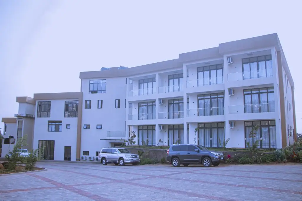 Exterior view of ESSENCIA Kivu Hotel in Rusizi, Rwanda, showcasing its modern architecture and lakeside location.
