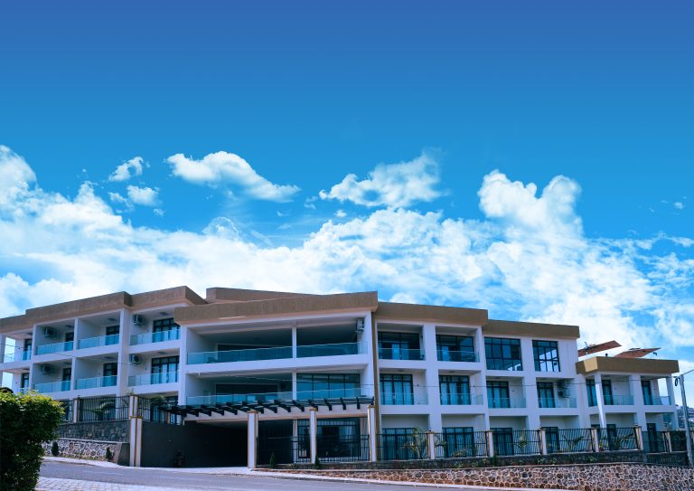 Exterior view of ESSENCIA Kivu Hotel in Rusizi, Rwanda, showcasing its modern architecture and lakeside location.